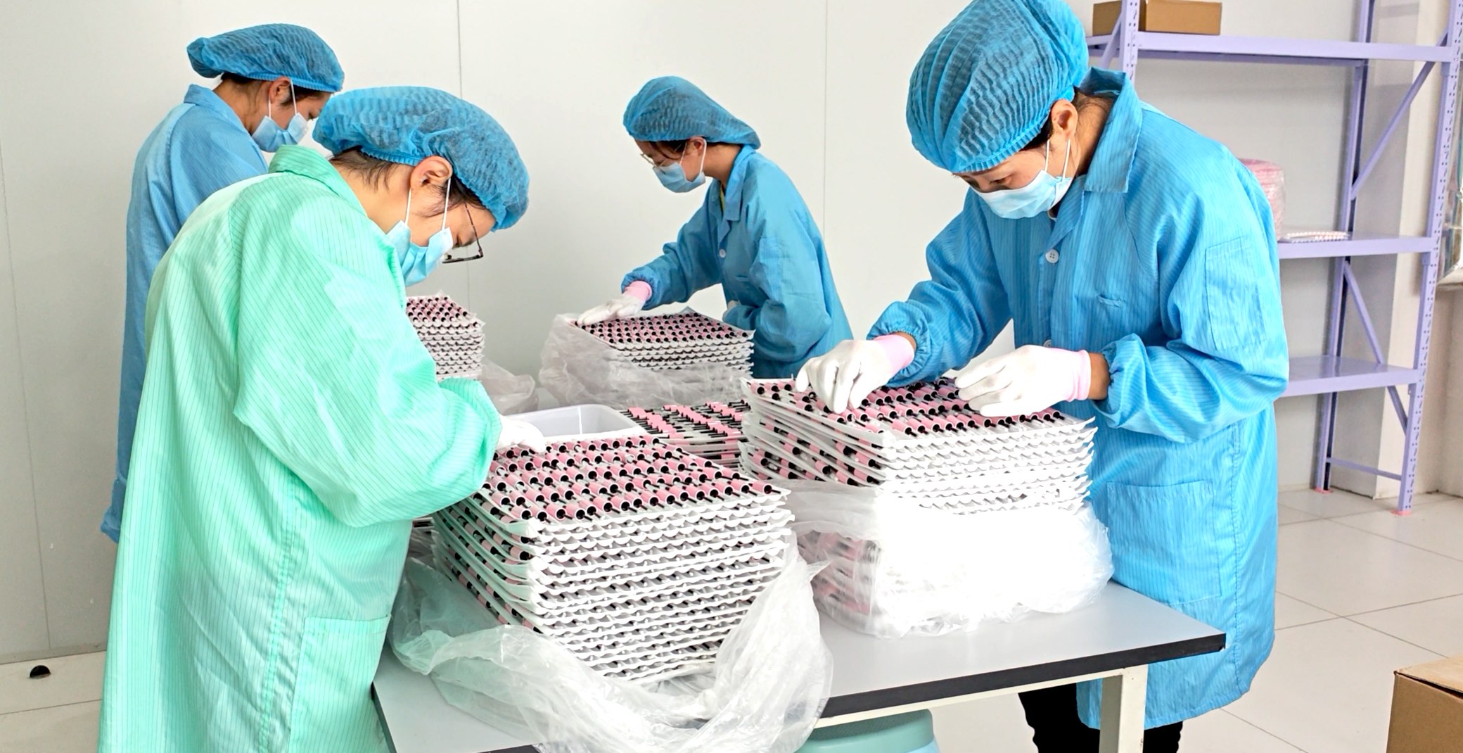 Just Lady workers sorting and inspecting empty cosmetic packaging components