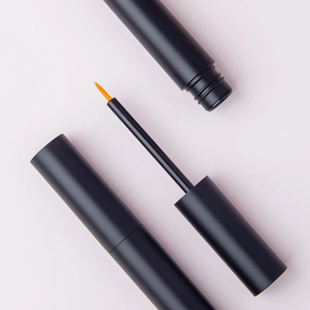Top view of matte black empty eyeliner tube with fine tip brush applicator, cosmetic packaging for liquid makeup